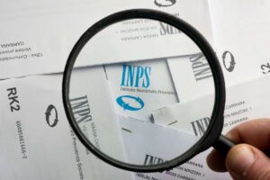 un foglio con scritto inps e una lente di ingrandimento sulla scritta