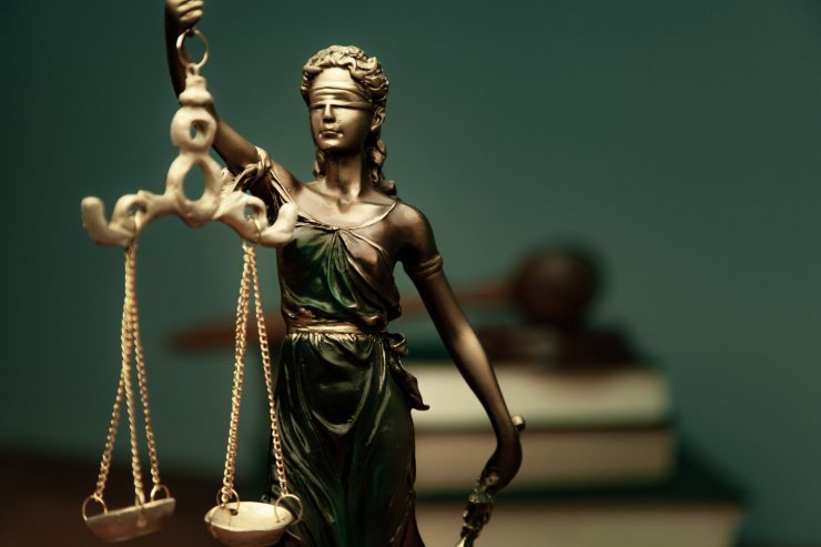 statua della dea bendata che tiene in mano la bilancia della giustizia